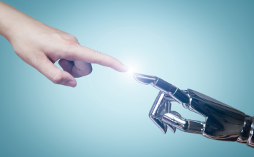 A Q&A With ChatGPT On AI For Events Human and robot hands reaching out to touch fingers in the center of the image