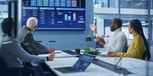 Business professionals meeting to discuss data results.