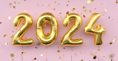 Gold balloons against a pink background that spell out