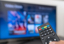 What We’re Streaming: AAE’s Watch List of Binge-Worthy Shows TV remote being held up in front of a TV screen