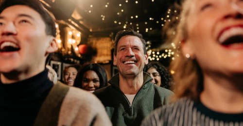 Audience members laughing