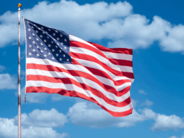 America 250: Experts on America’s Founding and Future American flag against backdrop of blue sky and clouds