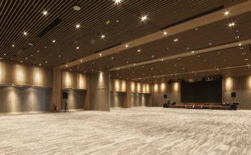 Corporate Event Trends 2026: 5 Takeaways from PCMA Empty corporate event ballroom with stage and presentation screen