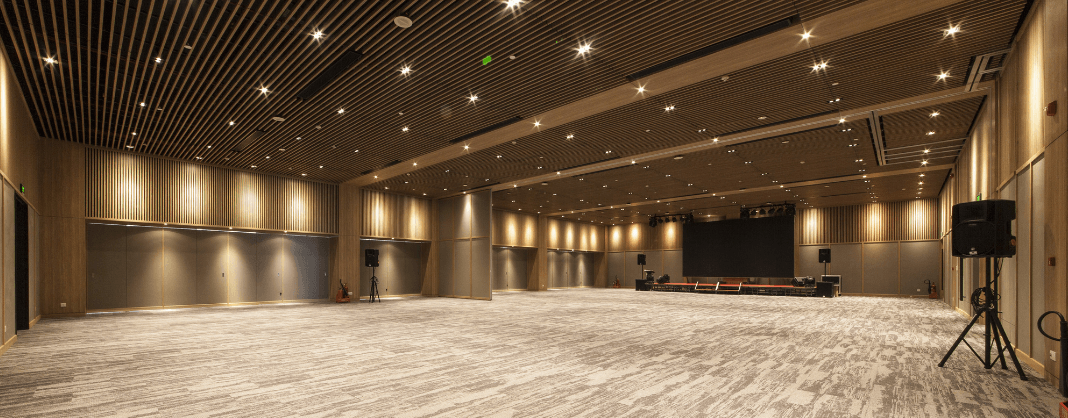 Corporate Event Trends 2026 5 Takeaways from PCMA Empty corporate event ballroom with stage and presentation screen