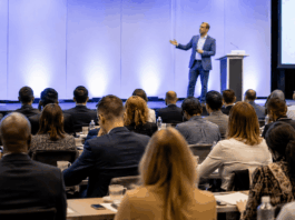 Speaker Customization: Evaluating Depth Before Booking Professional event setting with engaged audience listening to a speaker on stage, representing the high stakes and importance of speaker selection and customization.